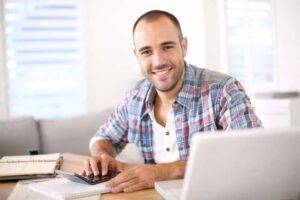 Man working on laptop computer from home | RDM Inc records management